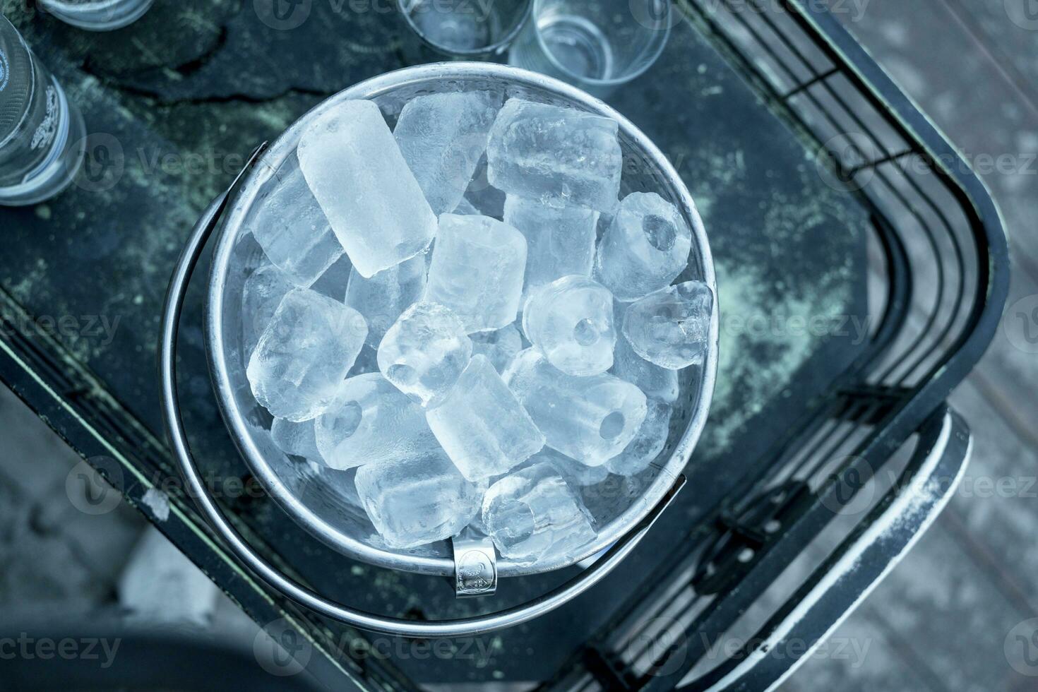 Several ice cubes in the ice bucket photo