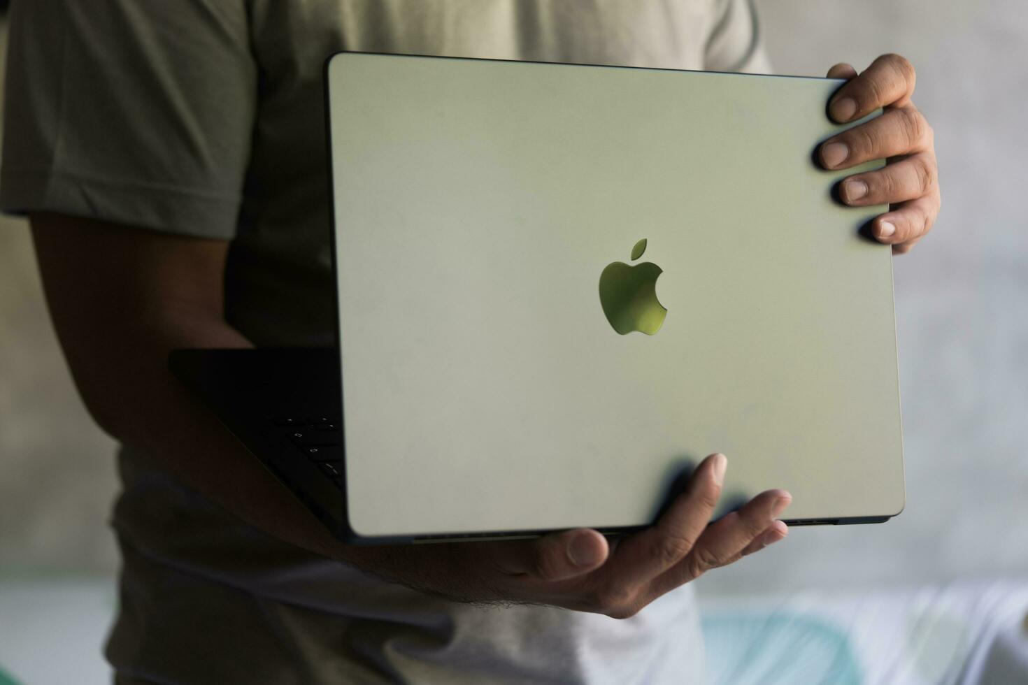 Bangkok Thailand, 24 December 2023 A young man open a new macbook pro M3 Max 14-Inch specs. photo