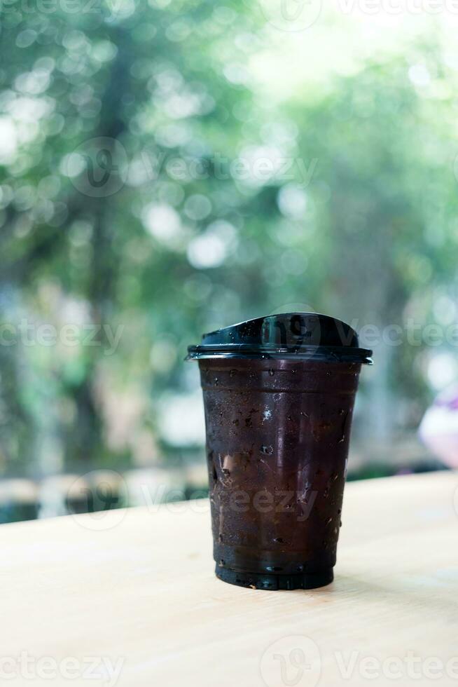 Iced black coffee or Americano coffee in takeaway glass photo