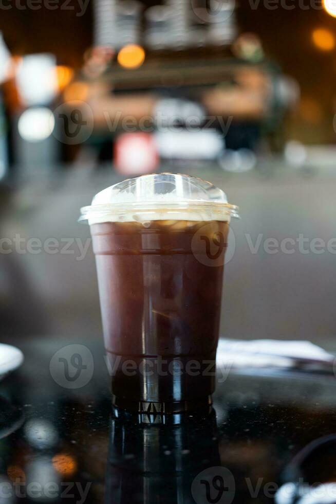 Takeaway plastic cup of iced black coffee or Americano. photo