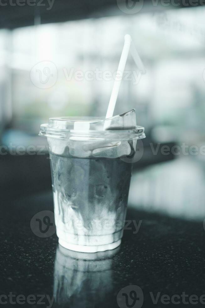 A cup of grey latte, mixed with charcoal and fresh milk photo