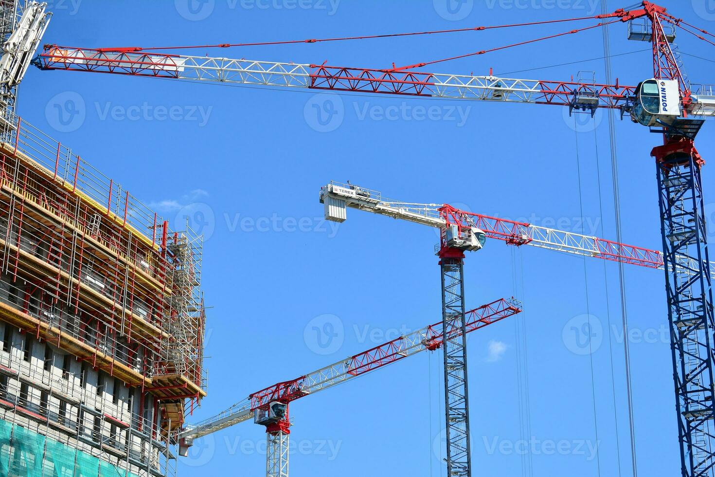 High rise building under construction. Installation of glass facade panels on a reinforced concrete structure. photo