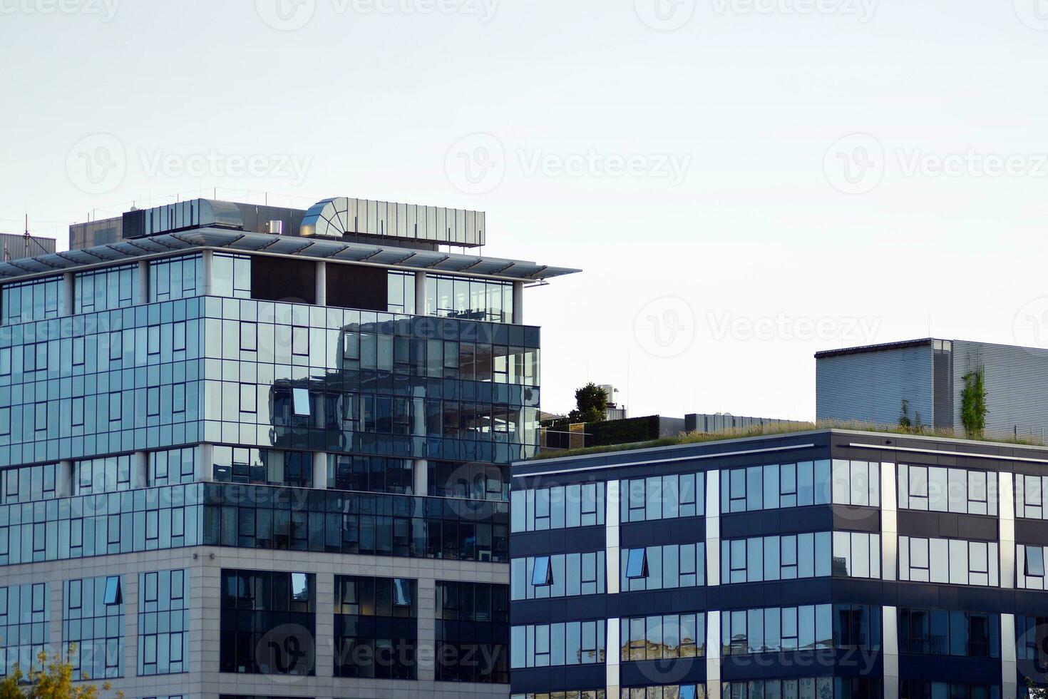 Glass building with transparent facade of the building and blue sky. Structural glass wall reflecting blue sky. photo