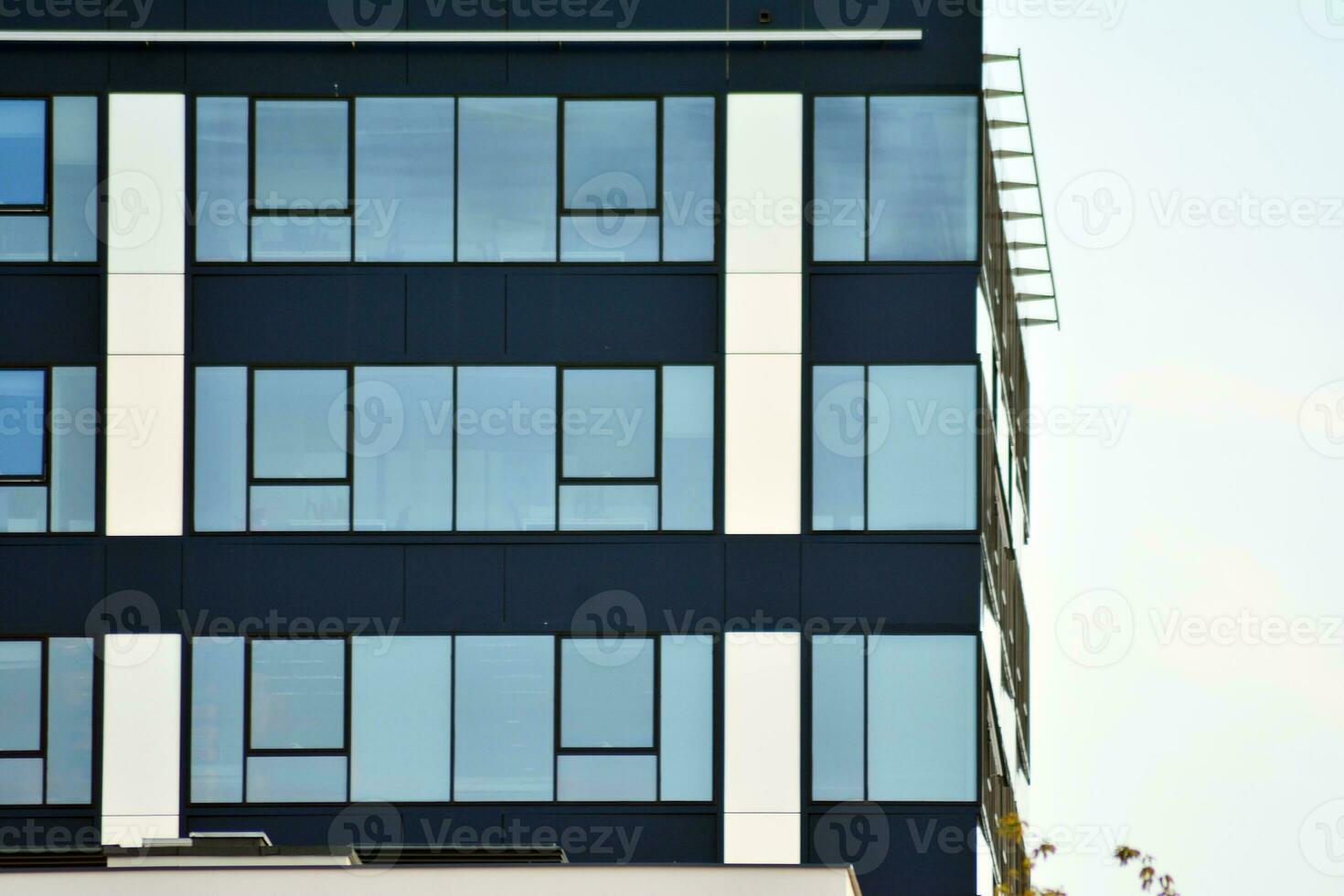 Glass building with transparent facade of the building and blue sky. Structural glass wall reflecting blue sky. photo