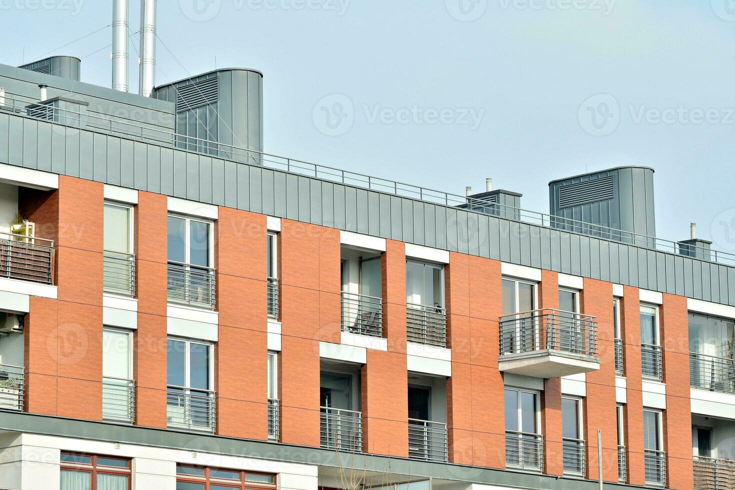 Abstract closeup of the glass-clad facade of a modern building covered in reflective plate glass. Architecture abstract background. Glass wall and facade detail. photo