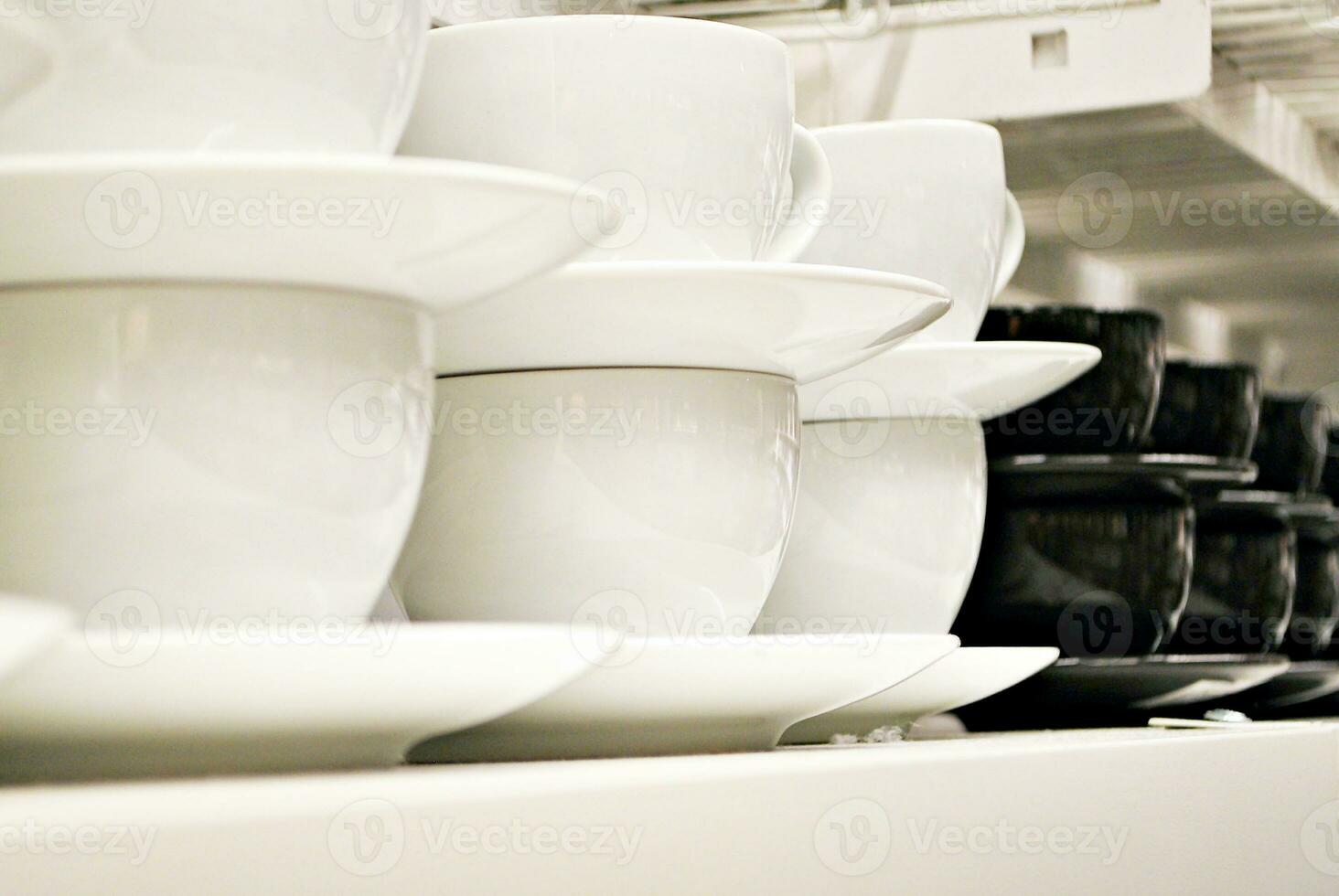 cups on the white shelves in the store photo