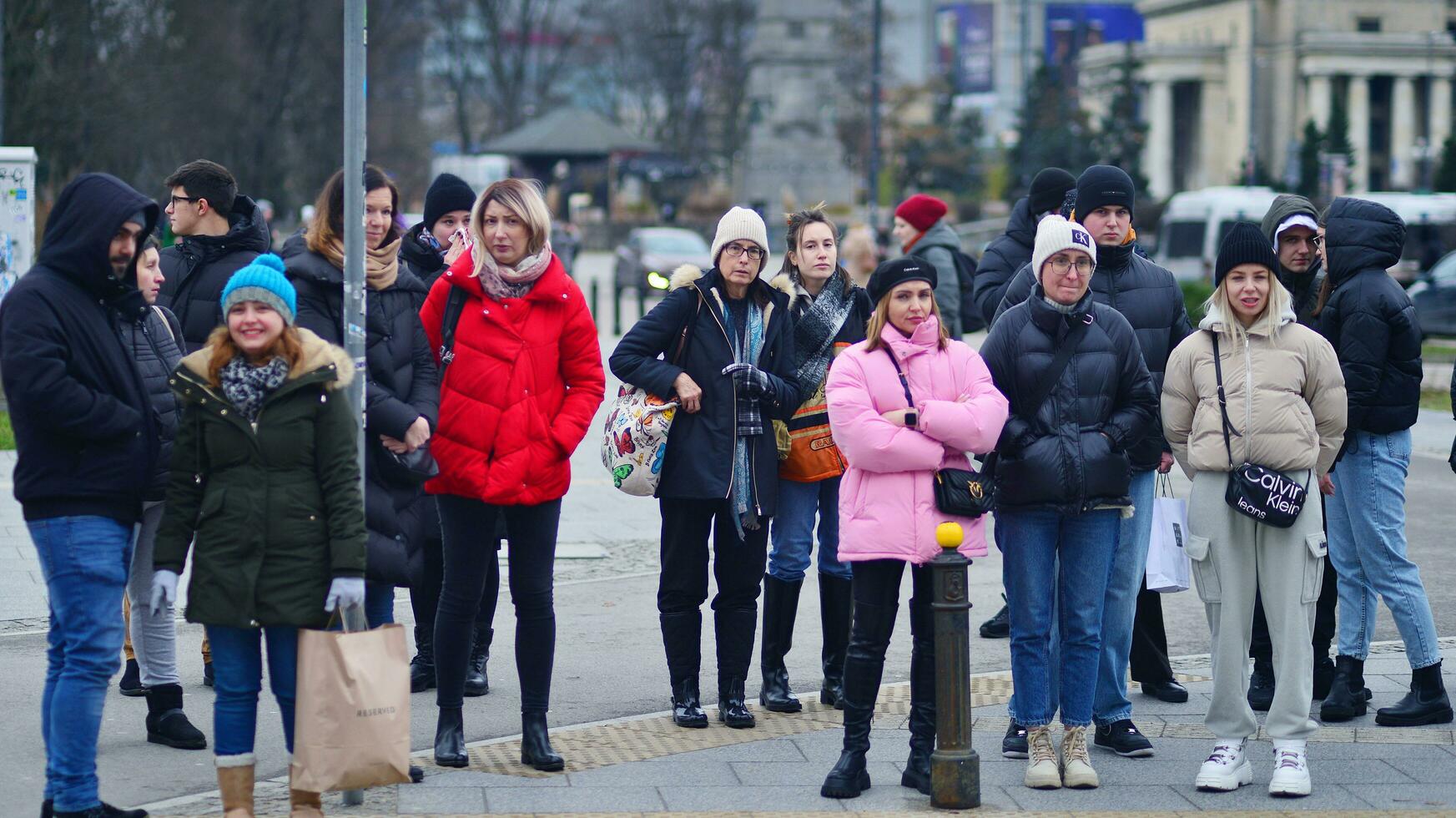 Warsaw, Poland. 29 December 2023. Crowd of people crossing street on traffic light zebra in the city  at rush hour. Lifestyle in a big city in Europa. photo