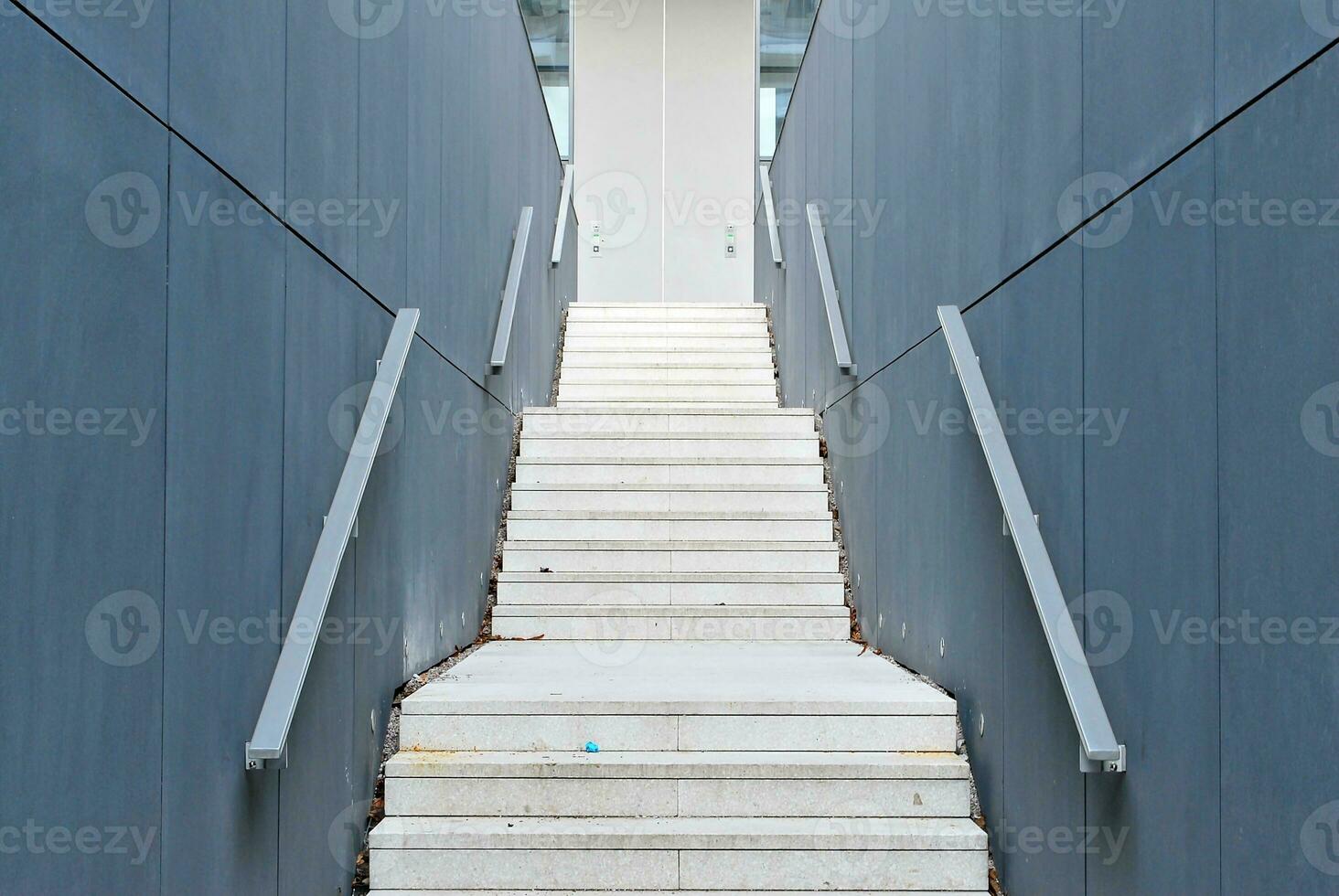 Abstract closeup of the glass-clad facade of a modern building covered in reflective plate glass. Architecture abstract background. Glass wall and facade detail. photo