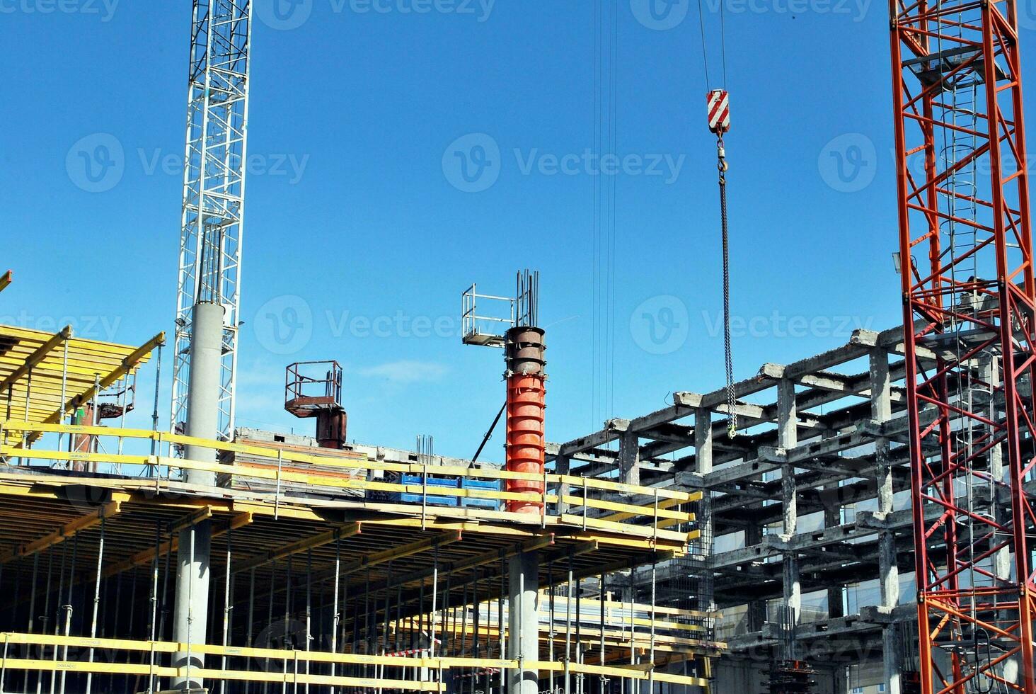 High rise building under construction. Installation of glass facade panels on a reinforced concrete structure. photo