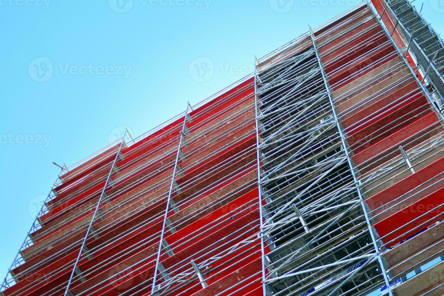 Abstract closeup of the glass-clad facade of a modern building covered in reflective plate glass. Architecture abstract background. Glass wall and facade detail. photo