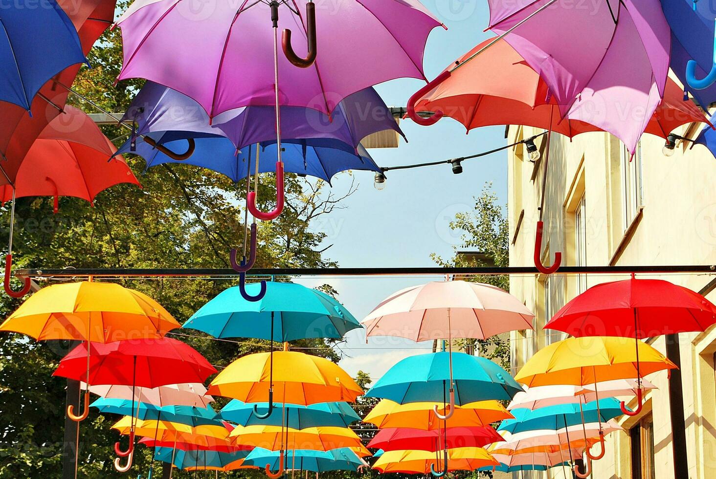 Colorful umbrellas background. Colorful umbrellas in the sky. Street decoration. photo