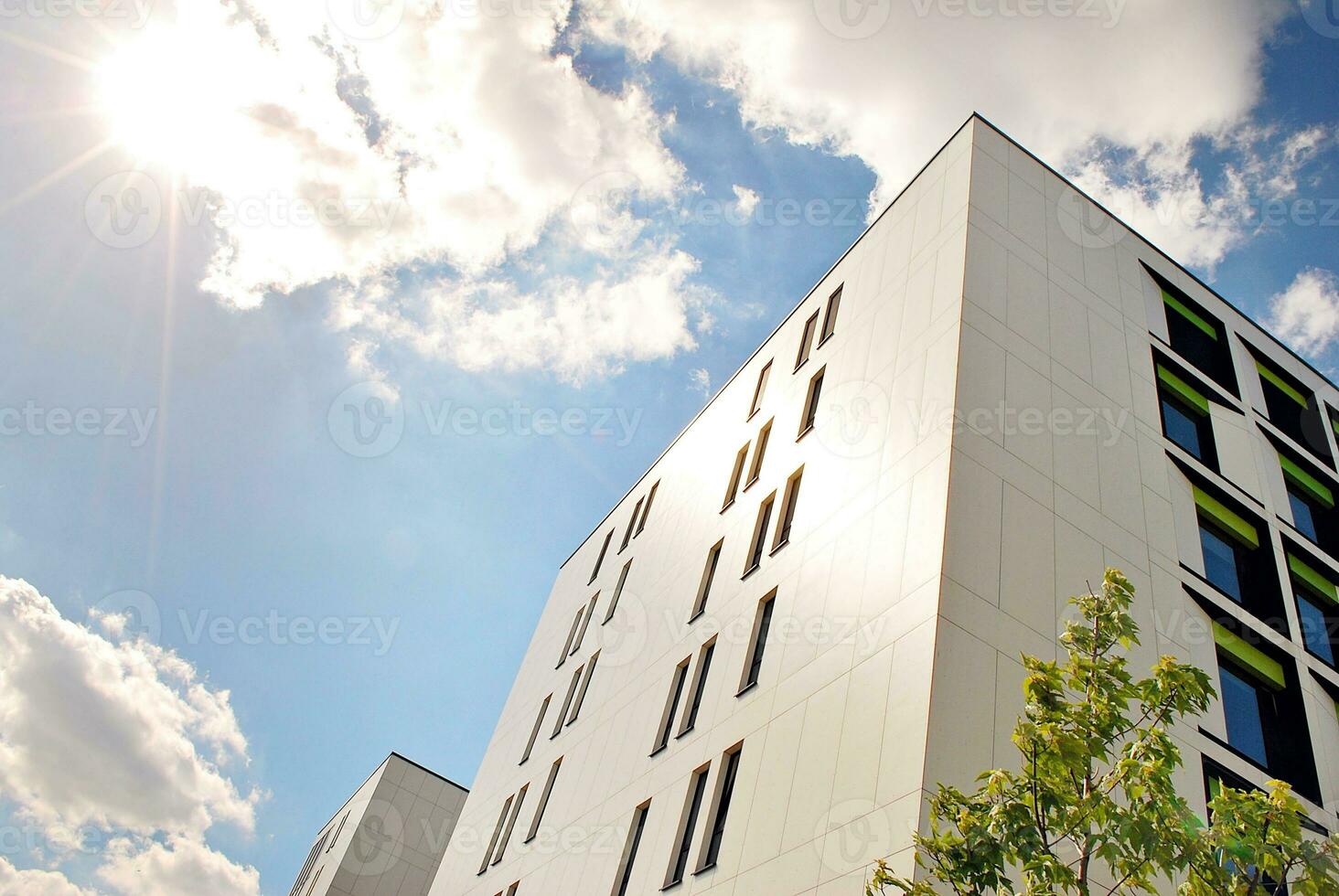 Abstract closeup of the glass-clad facade of a modern building covered in reflective plate glass. Architecture abstract background. Glass wall and facade detail. photo