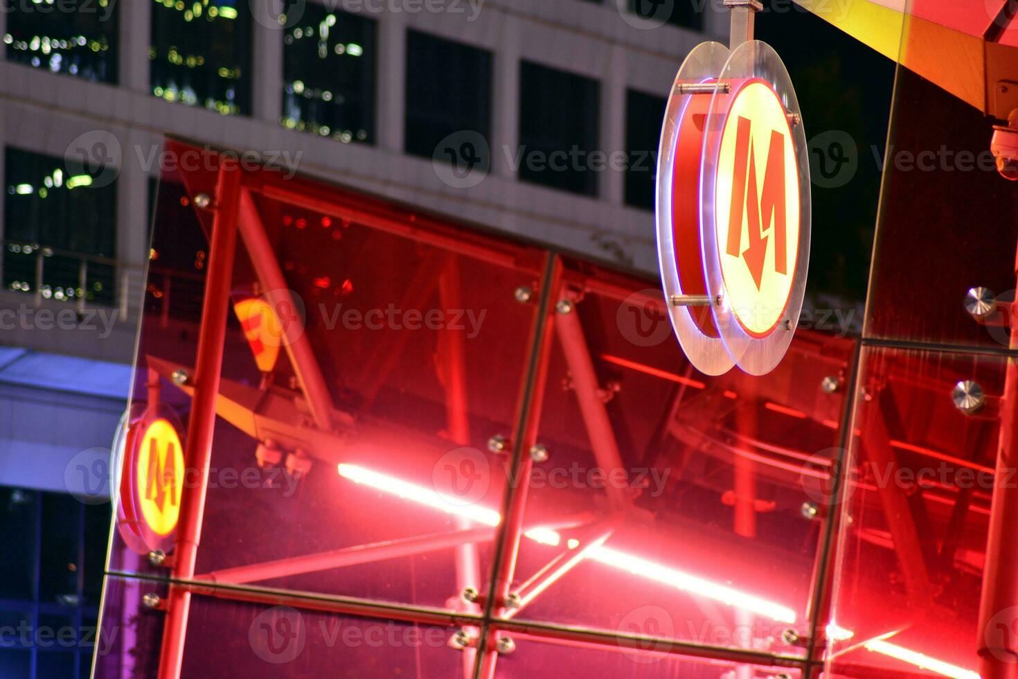 Fragment of the glass facade of a modern corporate building at night. Modern glass office  in city. Big glowing windows in modern office buildings at night, in rows of windows light shines. photo