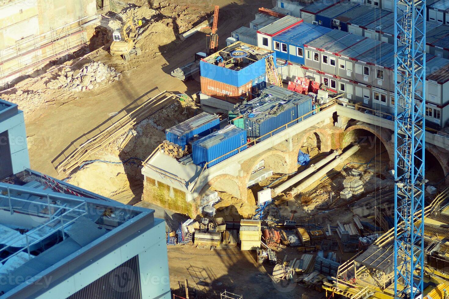 High rise building under construction. Installation of glass facade panels on a reinforced concrete structure. photo