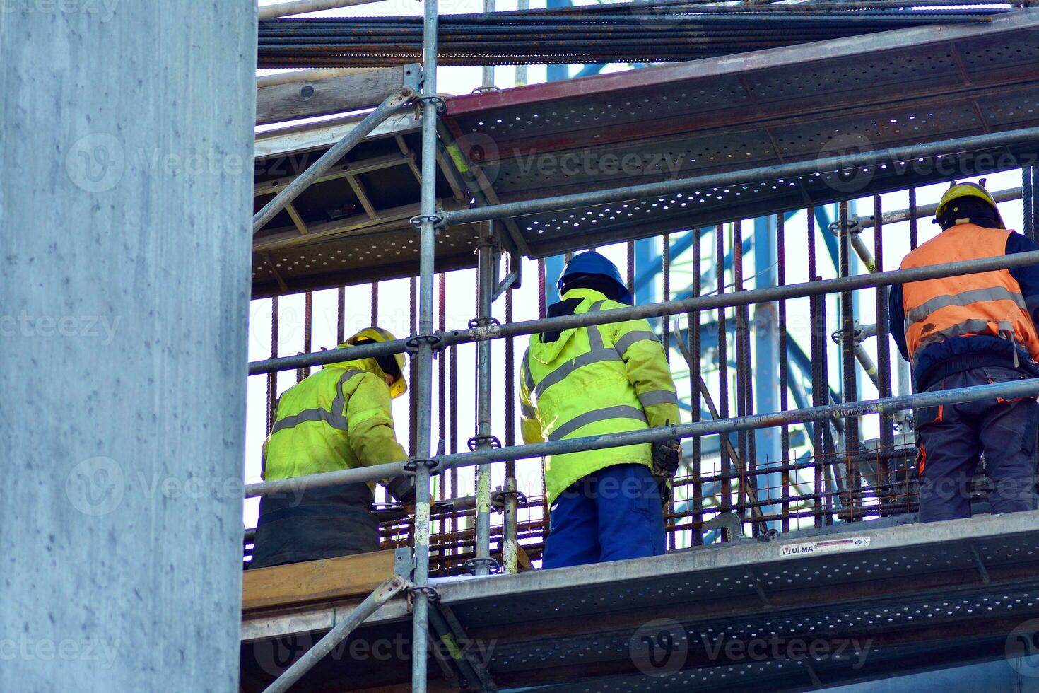 High rise building under construction. Installation of glass facade panels on a reinforced concrete structure. photo