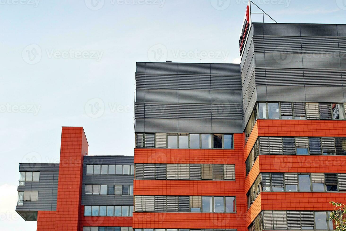 Abstract closeup of the glass-clad facade of a modern building covered in reflective plate glass. Architecture abstract background. Glass wall and facade detail. photo