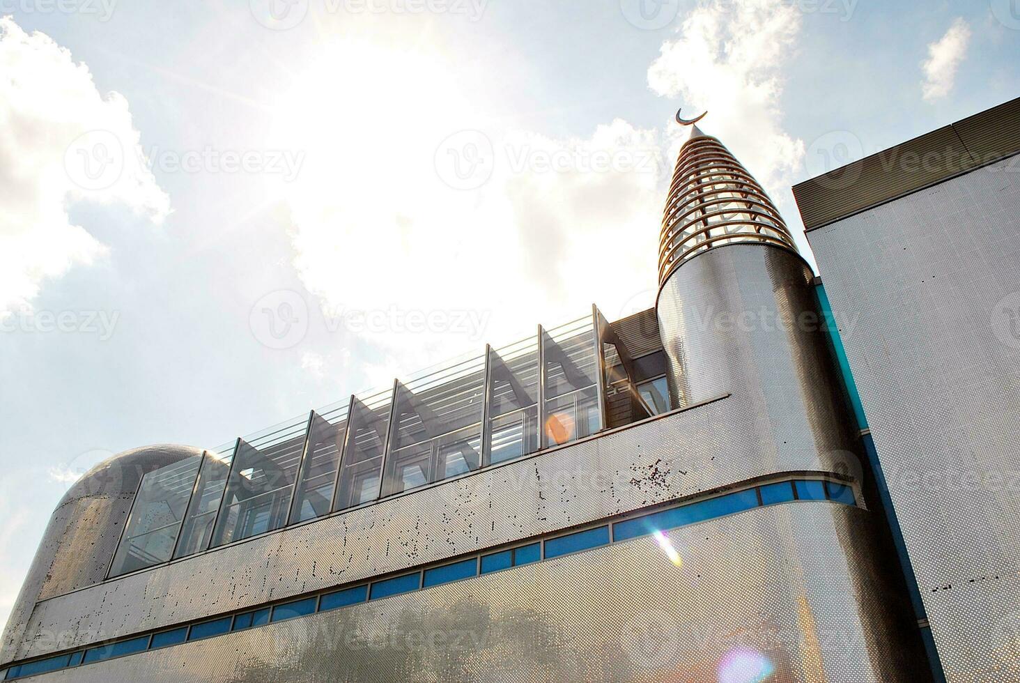 Abstract closeup of the glass-clad facade of a modern building covered in reflective plate glass. Architecture abstract background. Glass wall and facade detail. photo