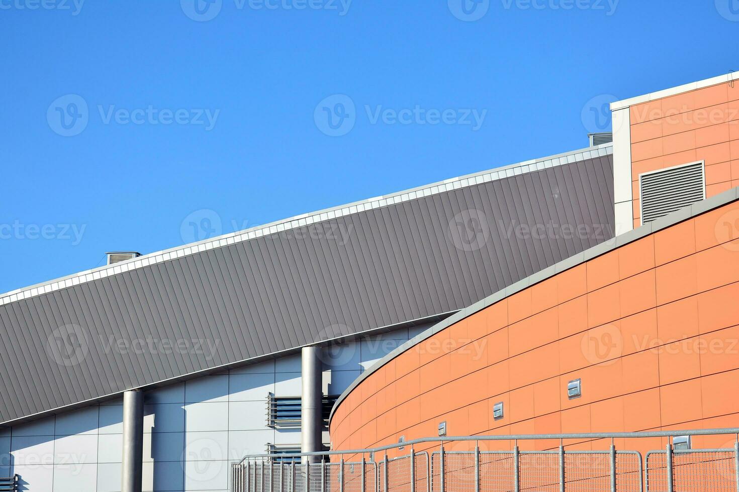 Abstract closeup of the glass-clad facade of a modern building covered in reflective plate glass. Architecture abstract background. Glass wall and facade detail. photo