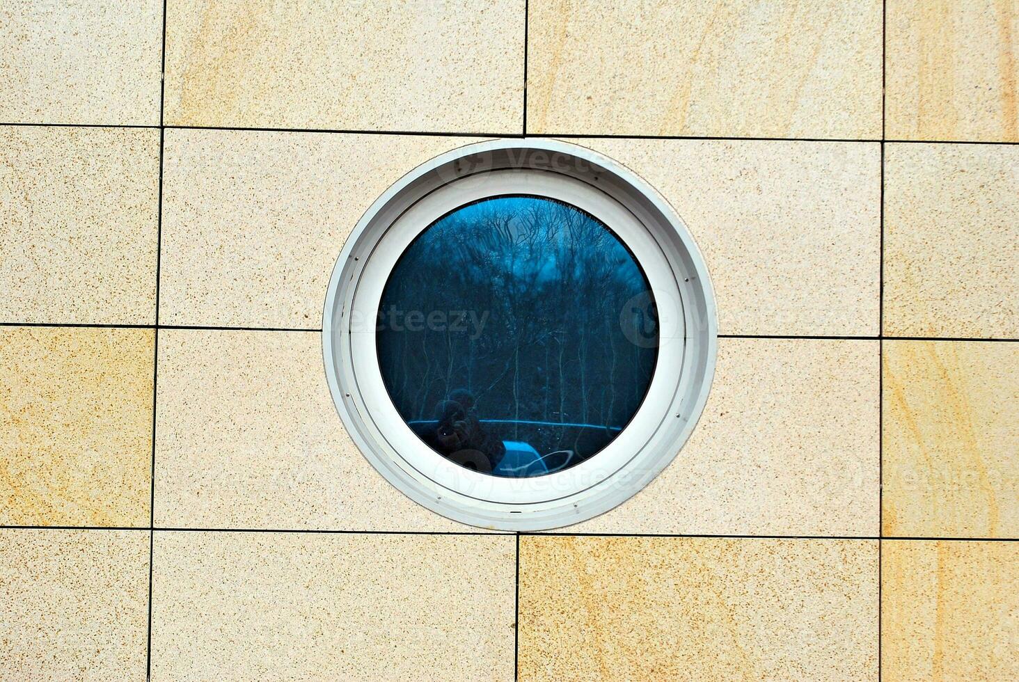Abstract closeup of the glass-clad facade of a modern building covered in reflective plate glass. Architecture abstract background. Glass wall and facade detail. photo