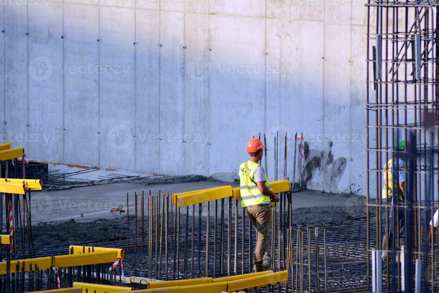 High rise building under construction. Installation of glass facade panels on a reinforced concrete structure. photo