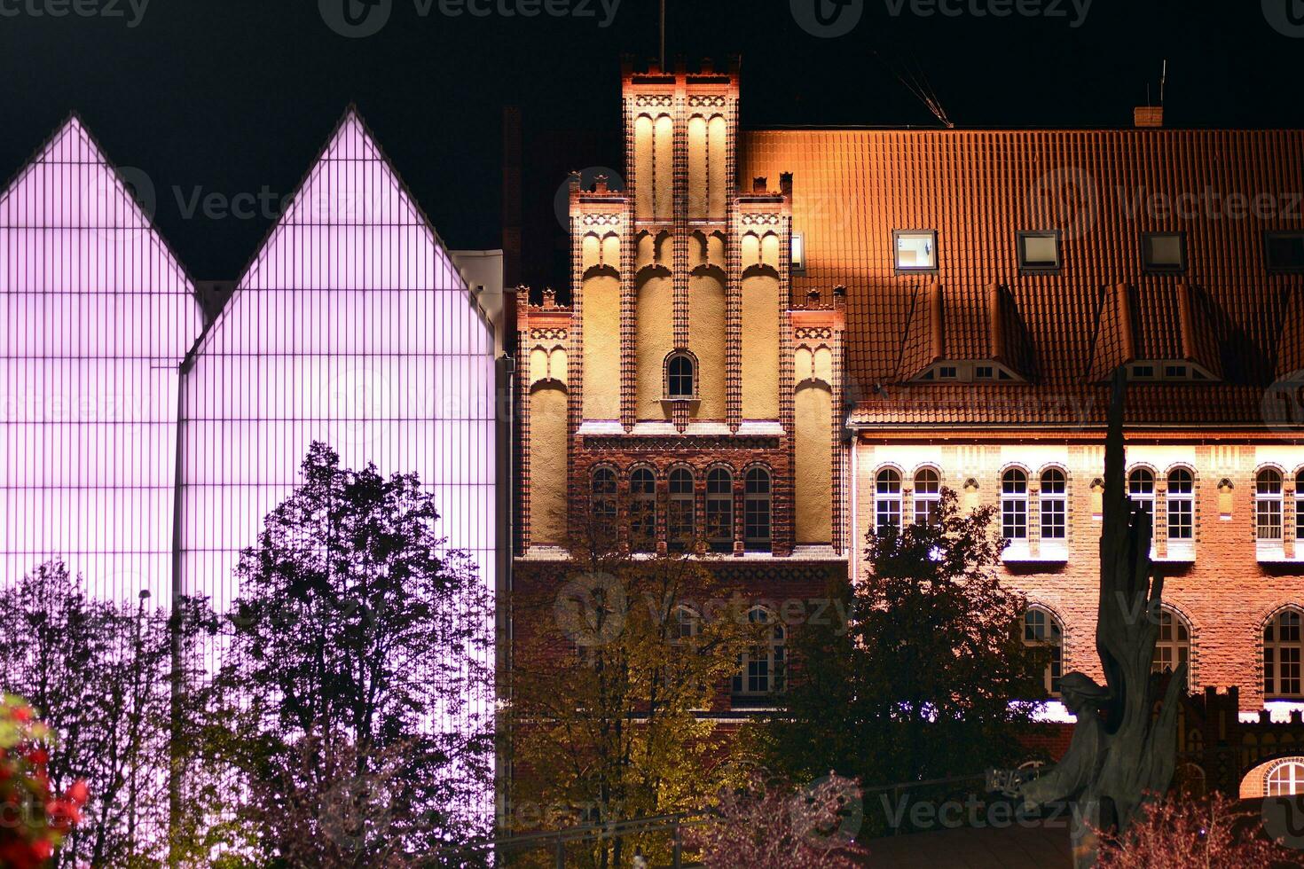 Pattern of office buildings windows illuminated at night. Glass architecture ,corporate building at night - business concept. photo