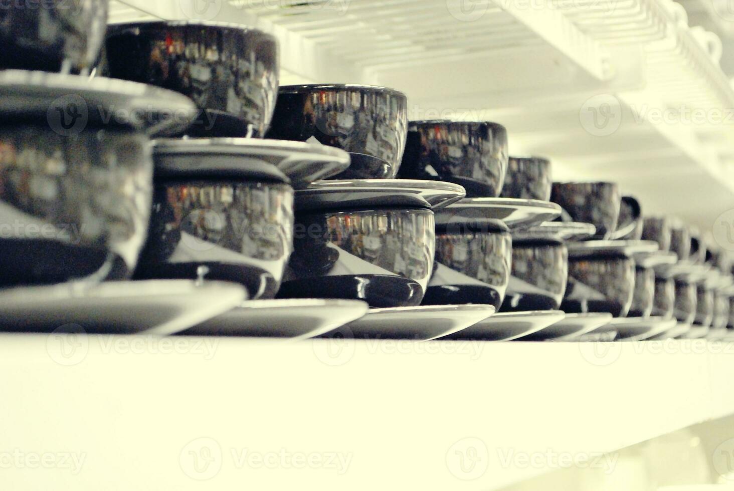 cups on the white shelves in the store photo