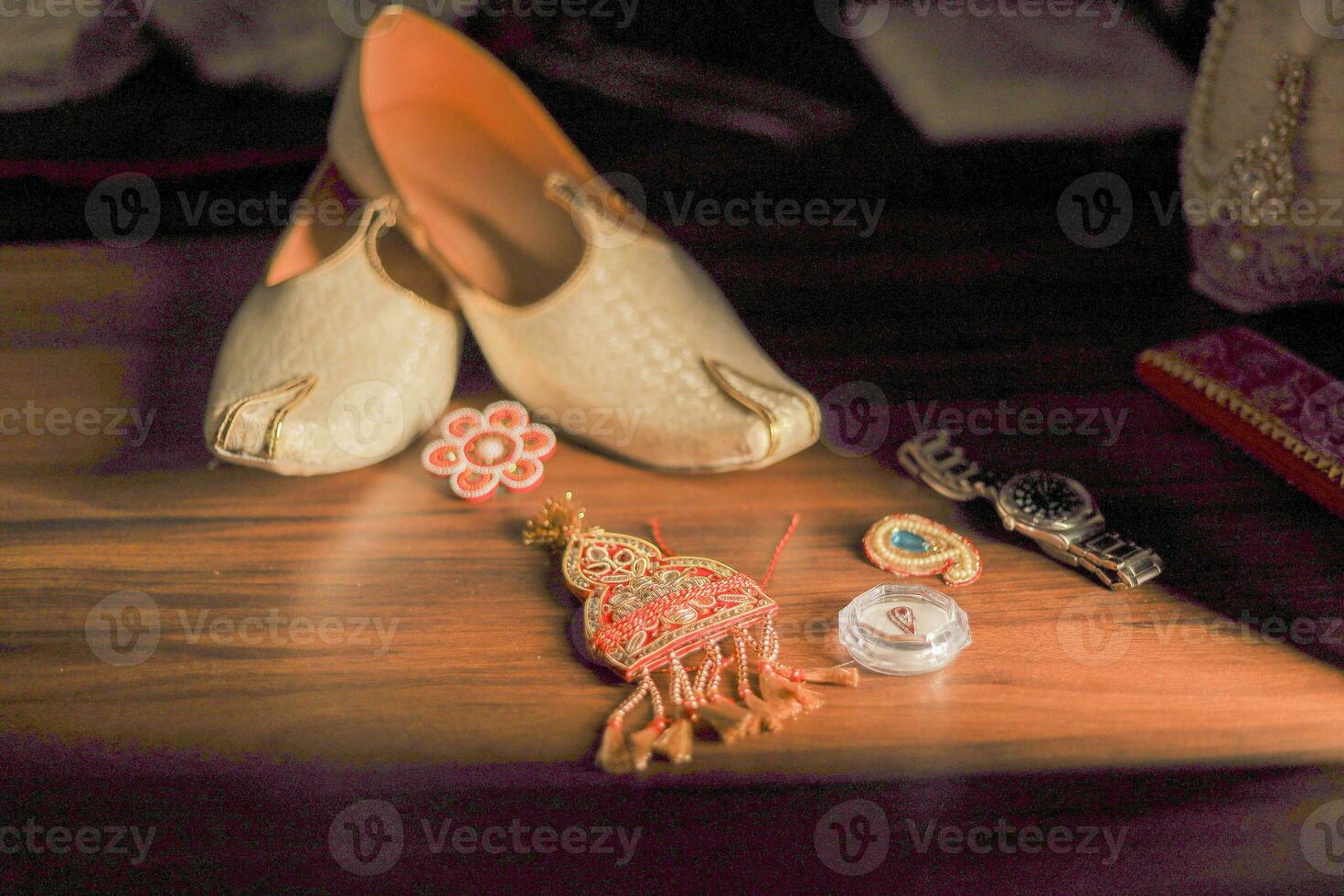 Indian groom's traditional wedding jewelry and shoes close up photo