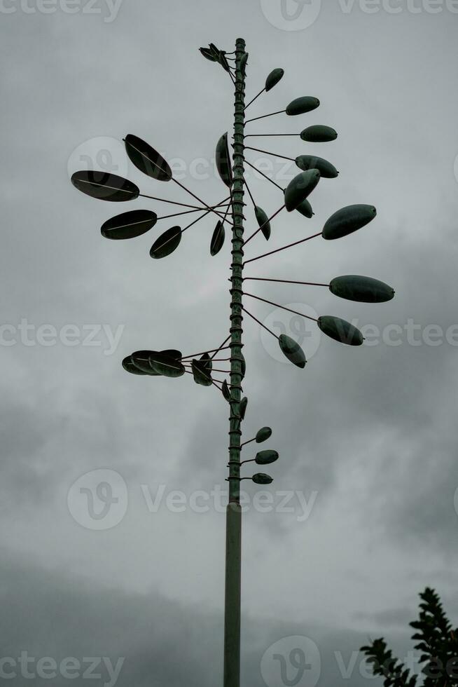 Unique Wind Vane Design Under Gloomy Sky photo