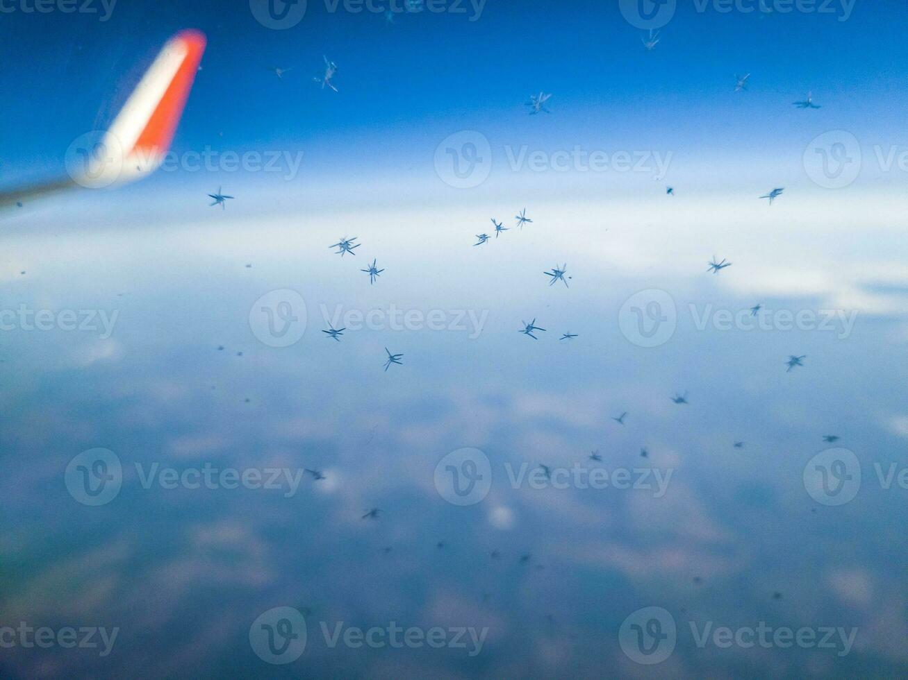 Shot of the snowflakes on the window of the airplane. Aviation photo