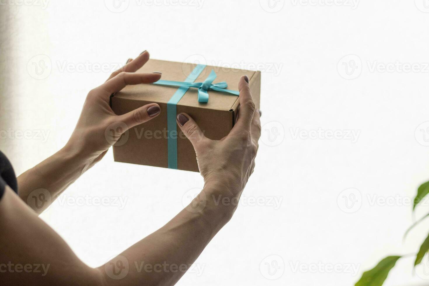 Close up shot of the woman holding rapped gift box. Holiday photo