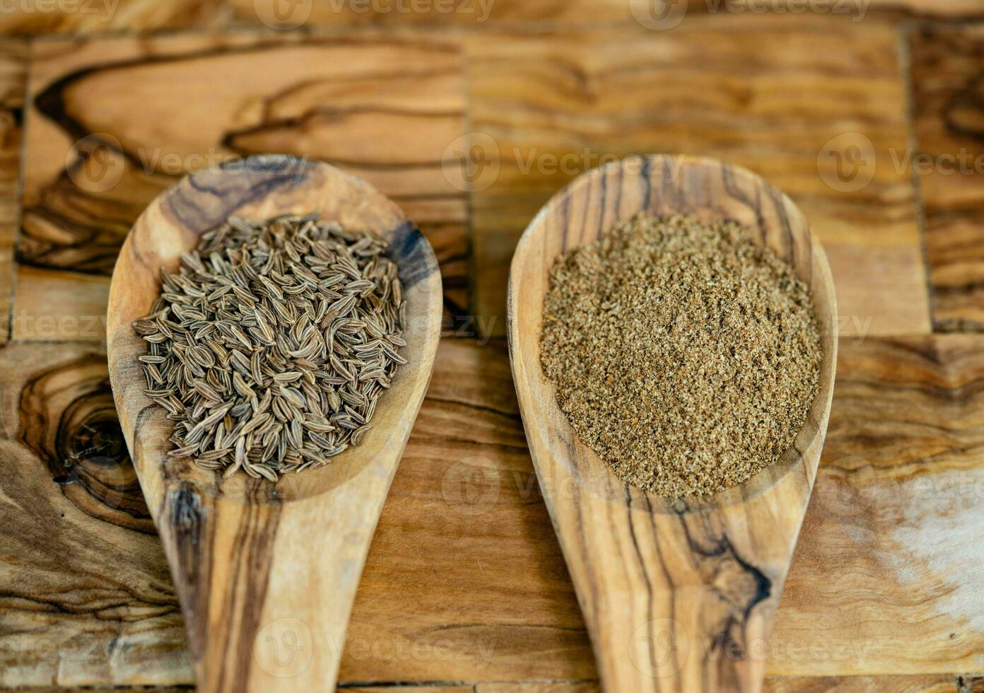 caraway seeds Carum carvi on olive wood photo