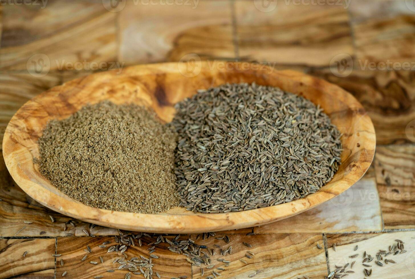 caraway seeds Carum carvi on olive wood photo