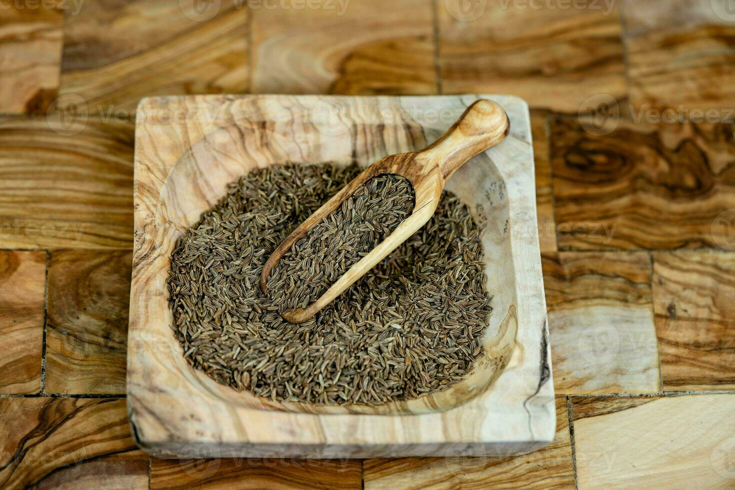 caraway seeds Carum carvi on olive wood photo