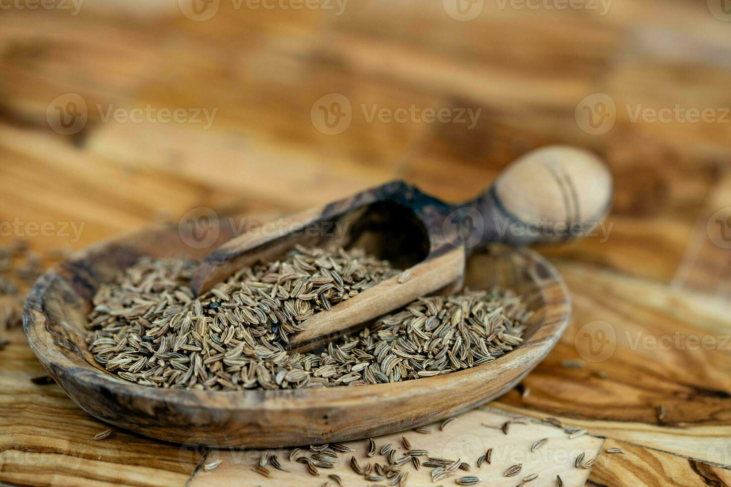 caraway seeds Carum carvi on olive wood photo