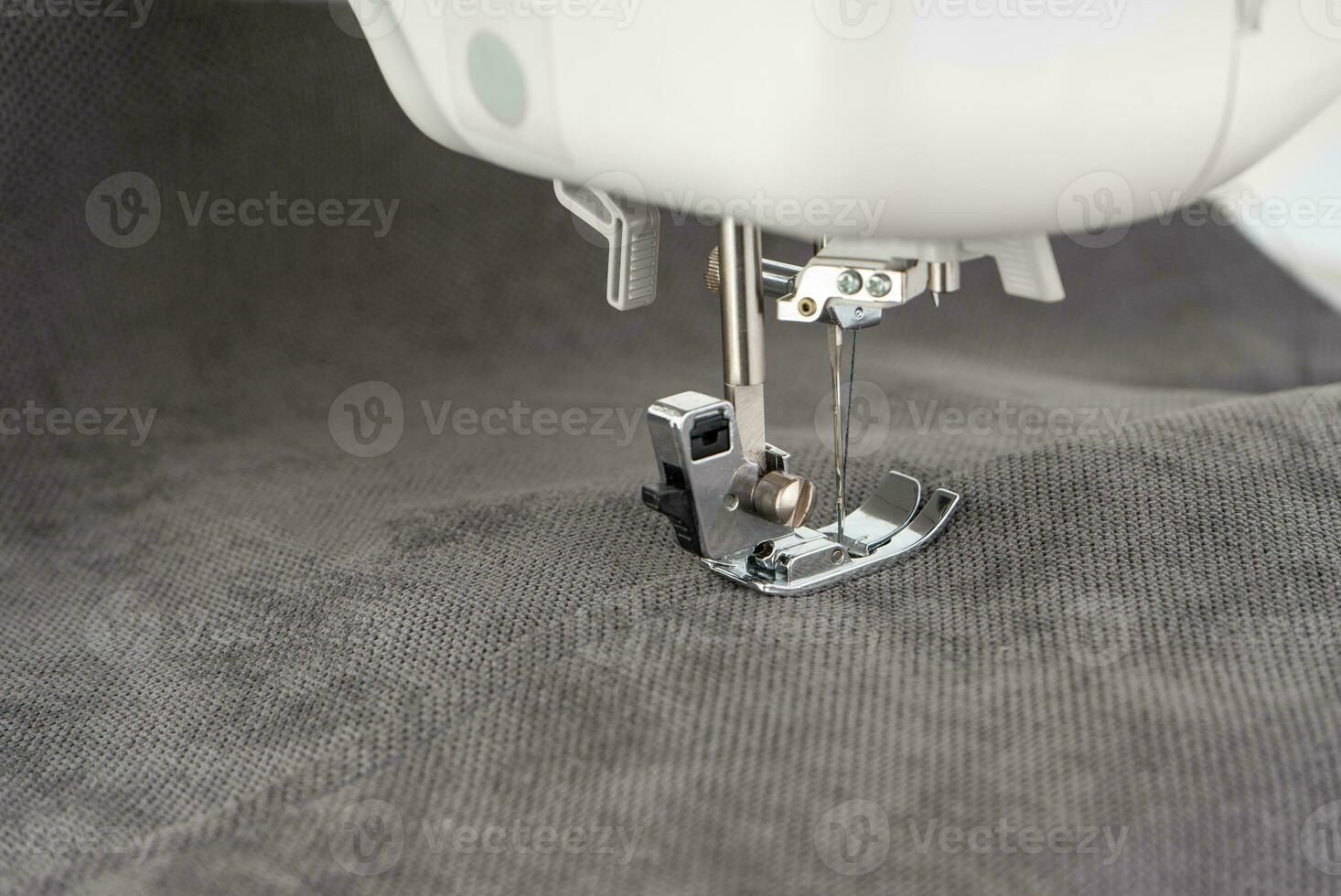Modern sewing machine with gray fabric photo