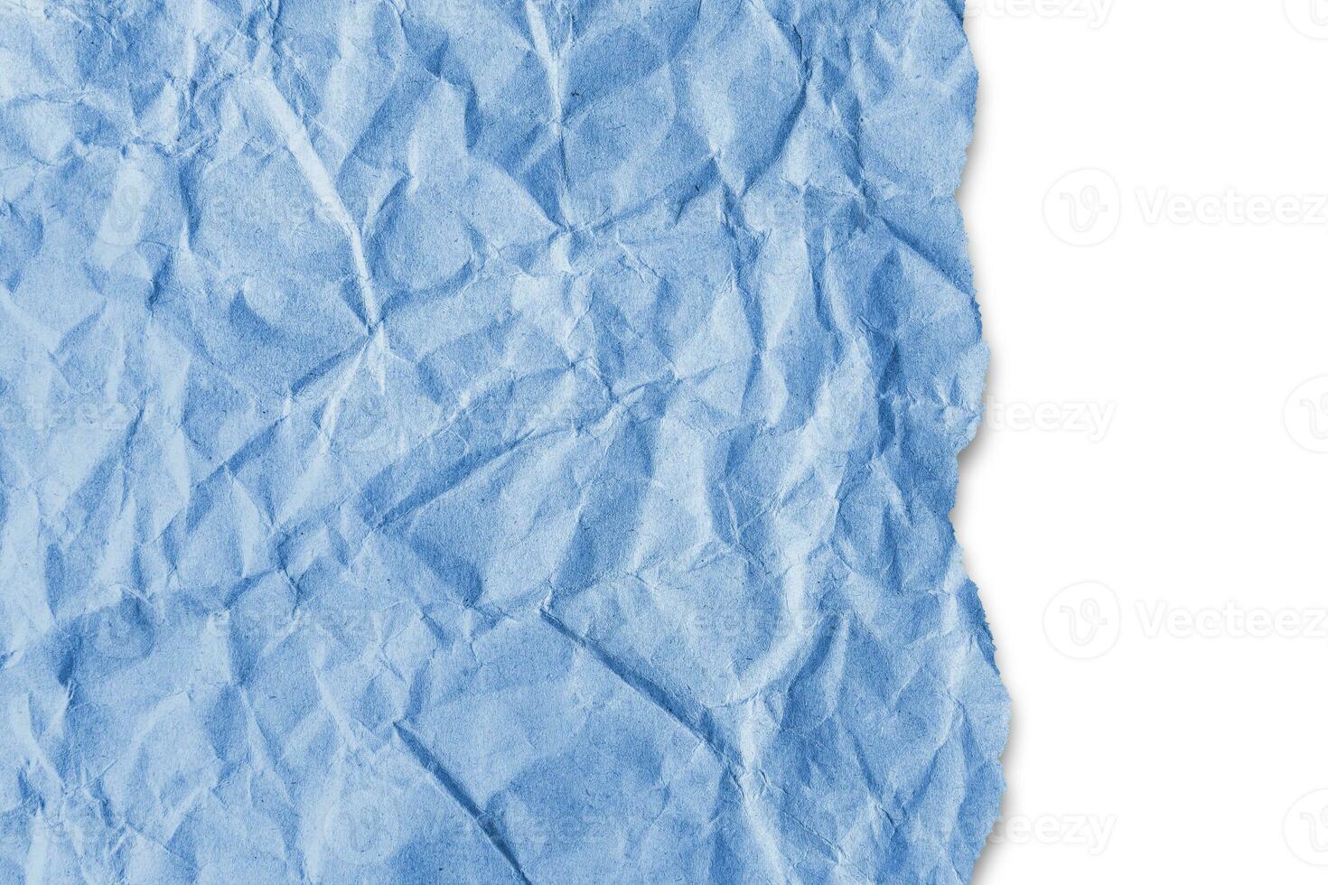 Recycled crumpled blue paper texture with a torn edge isolated on white background photo