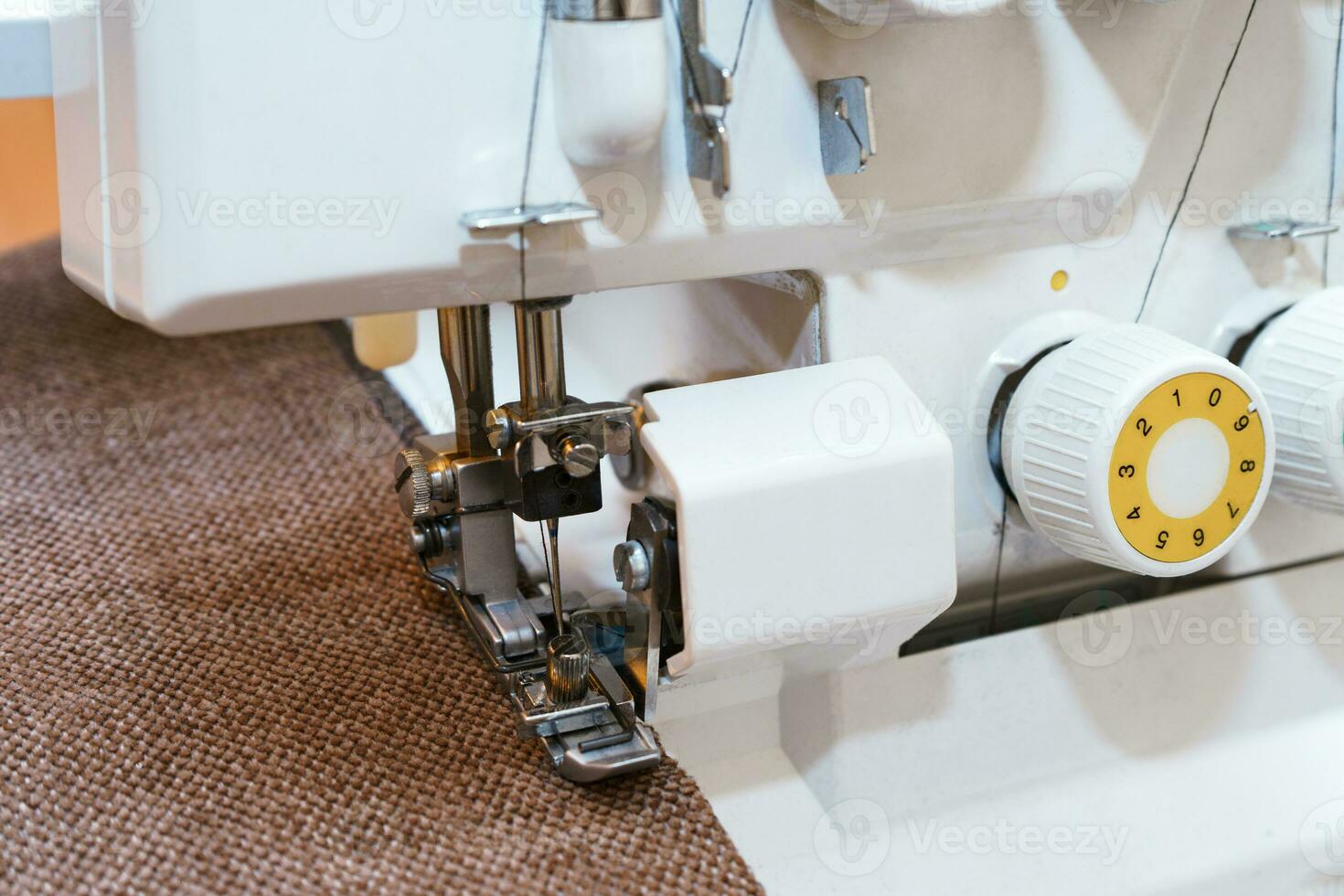Overlock sewing machine in process. Professional equipment photo
