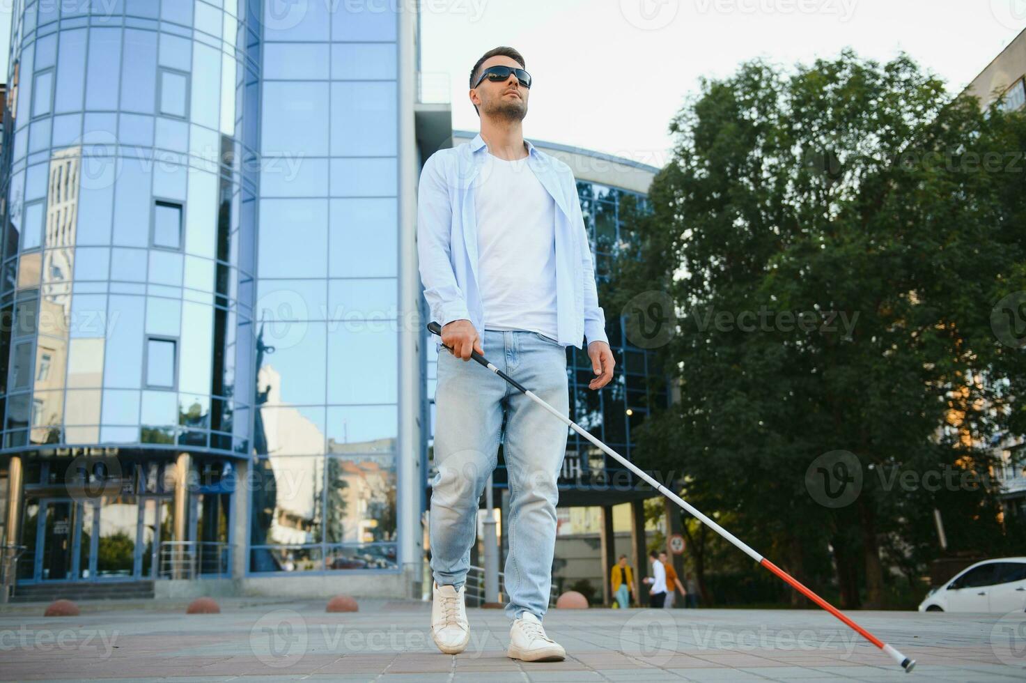 Blind man. Visually impaired man with walking stick, photo