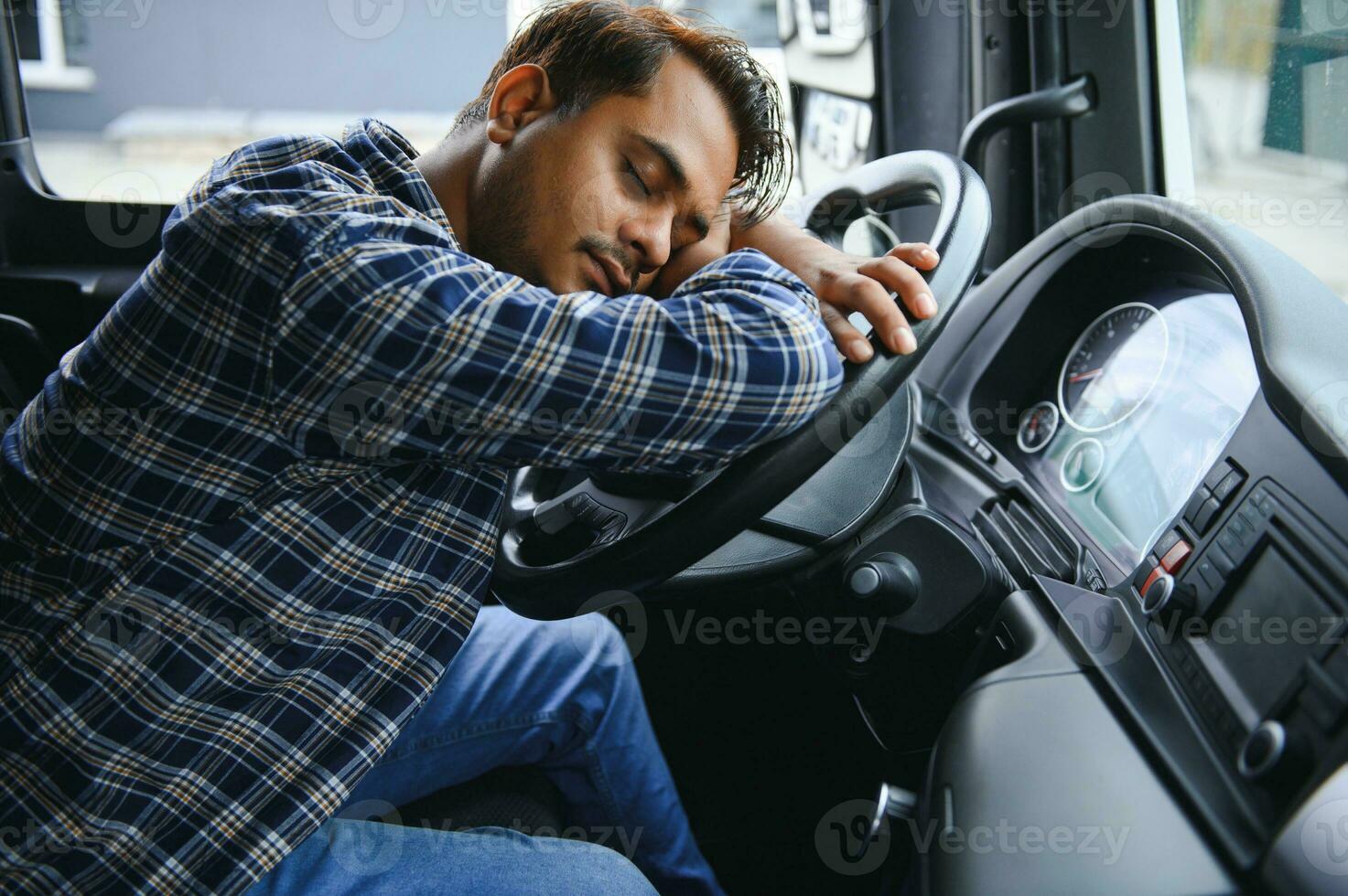 Portrait of tired indian truck driver feeling sleepy and sick. photo