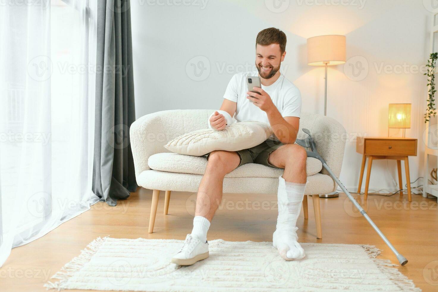Happy man recovery from accident fracture broken bone injury with leg and arm. Social security and health insurance concept photo