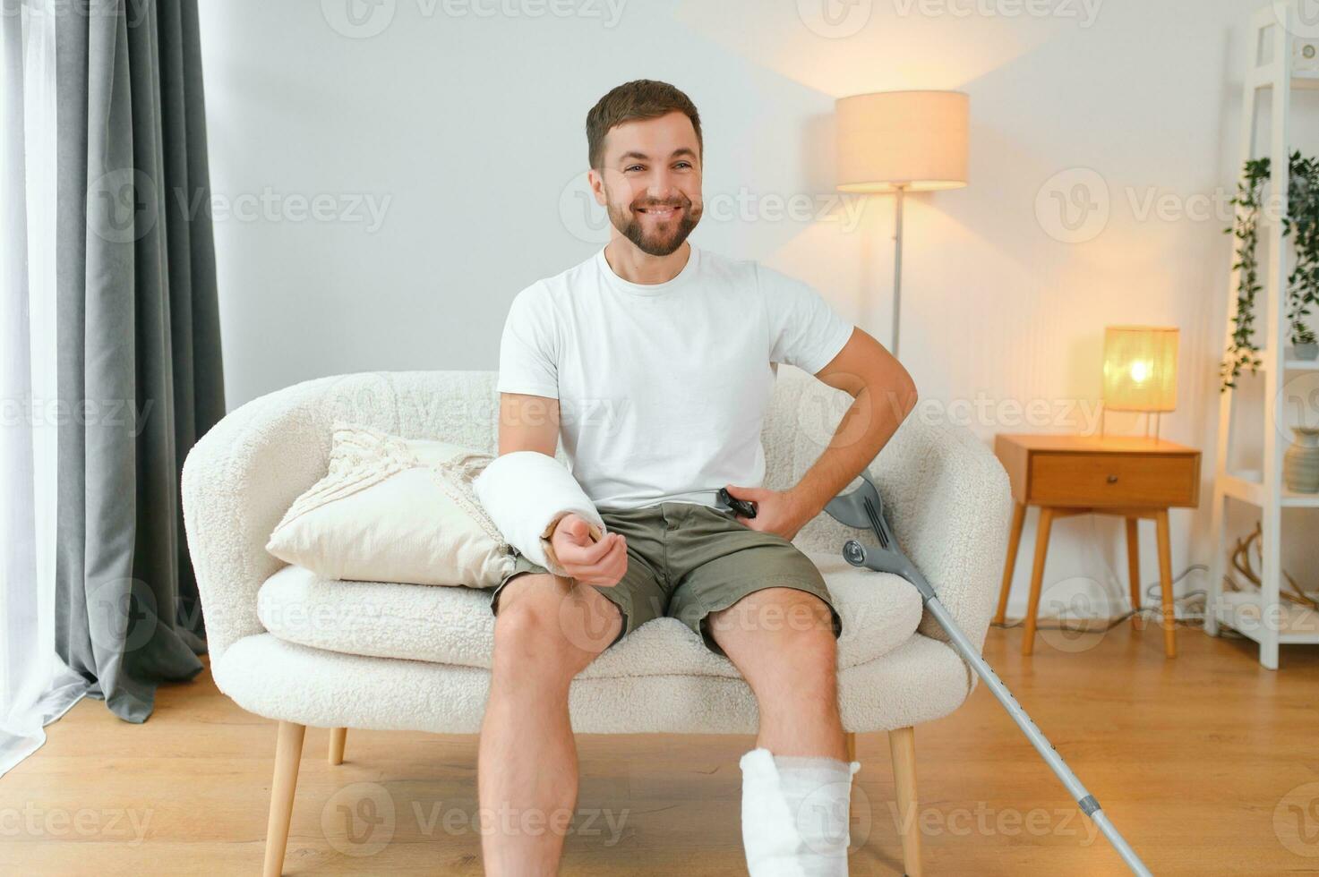 Happy man recovery from accident fracture broken bone injury with leg and arm. Social security and health insurance concept photo