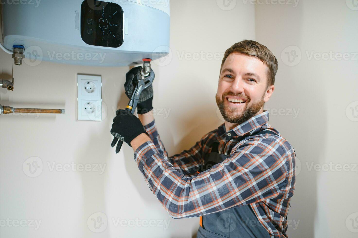 Professional plumber checking a boiler and pipes, boiler service concept photo