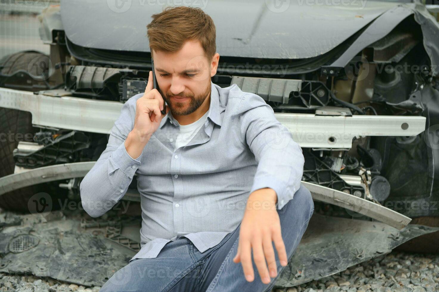 Man calling help after a car crash accident on the road photo