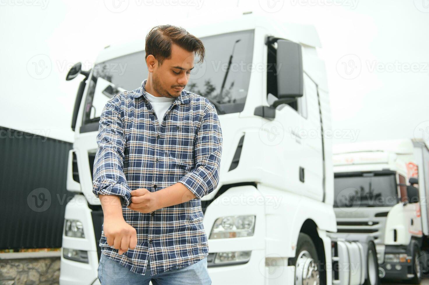 Young Indian truck driver. Concept of road freight transportation photo