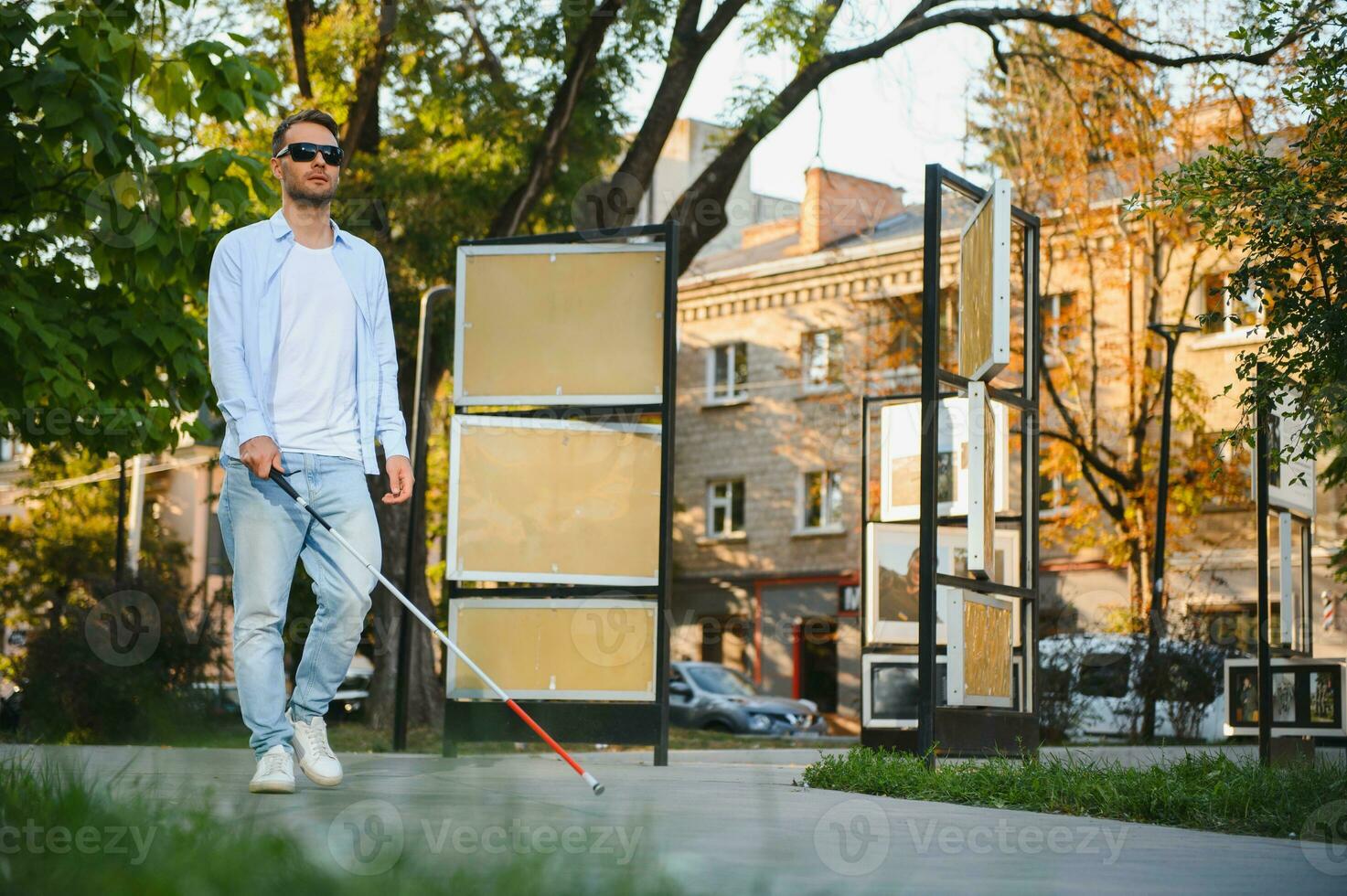 Blind man. Visually impaired man with walking stick, photo