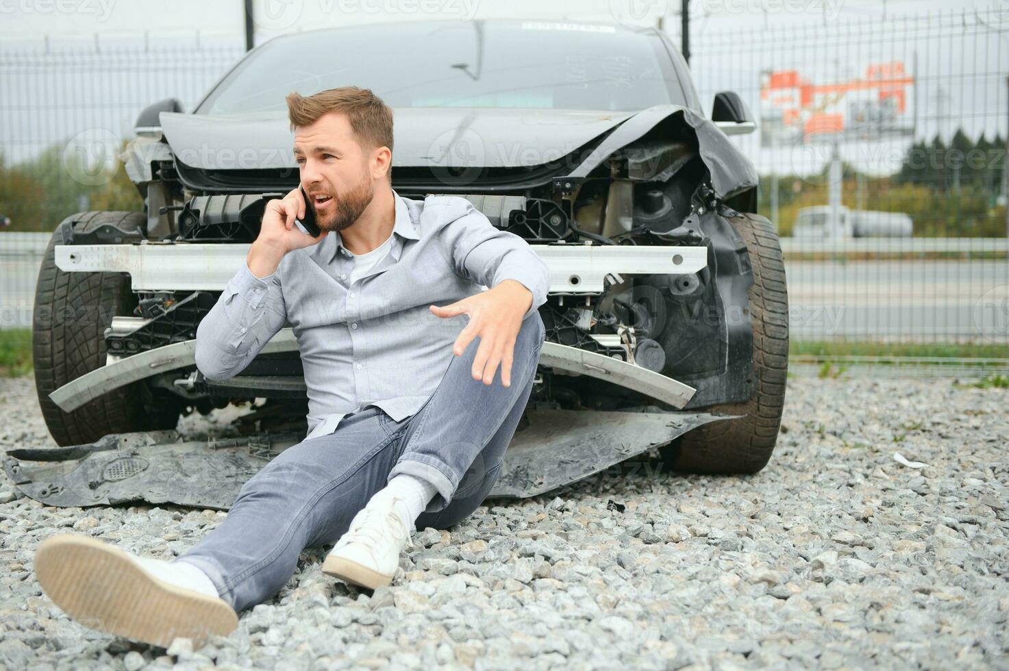 Man calling help after a car crash accident on the road photo