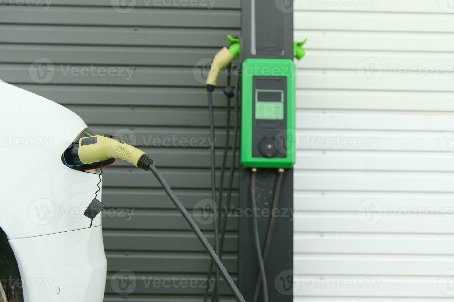 Electric Car on a charging station with back and light plug detail, electric mobility photo