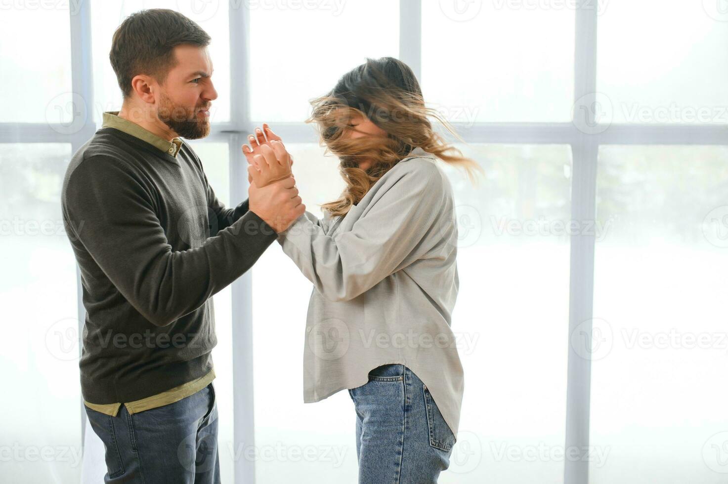 Angry husband beats his wife, domestic violence photo