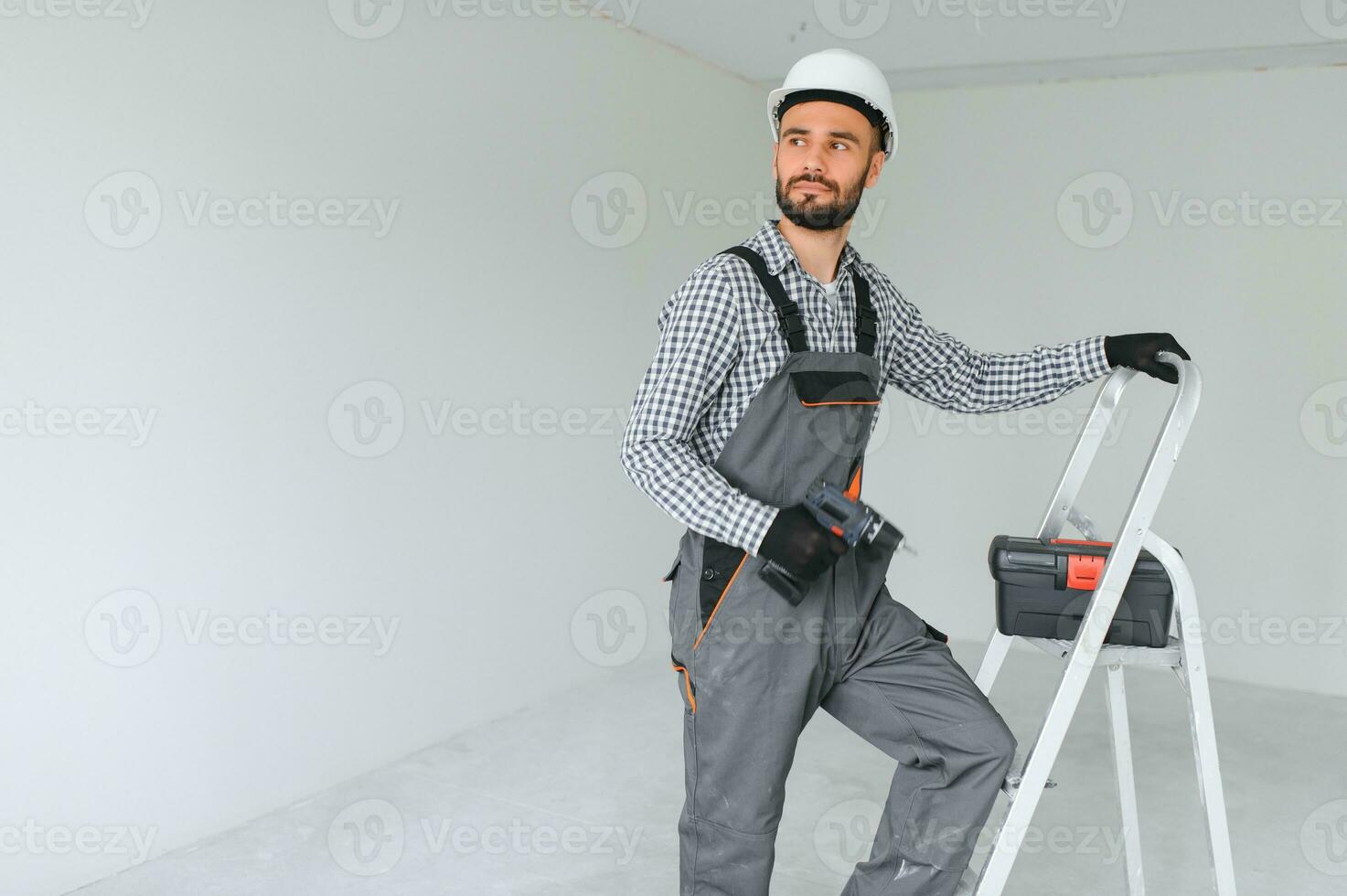 Portrait of a builder on a construction site indoors photo