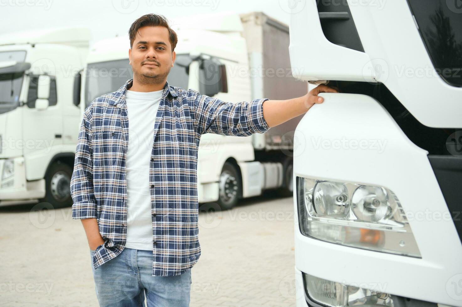 Young Indian truck driver. Concept of road freight transportation photo